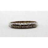 A 9ct yellow and white gold diamond set half eternity ring, (L.5).