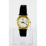 A boxed lady's Tissot 18ct yellow gold (stamped 18k) wrist watch on a leather strap.