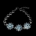 A 925 silver flower shaped bracelet set with marquise and round cut Swiss blue topaz, L. 17cm.