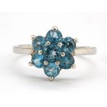 A 925 silver blue topaz set cluster ring, (R.5).