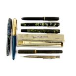 A group of mixed fountain pens and a hallmarked silver propelling pencil.