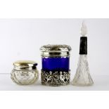 Two hallmarked silver topped glass toilette pots and a hallmarked silver mounted glass perfume