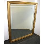A large gilt framed bevelled edge mirror, size 87 x 112cm.