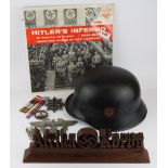 A German Nazi original LP record, reproduction Nazi helmet and carved wood Afrika Korps desk stand.