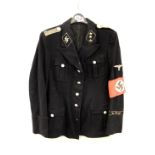 A 1940's German Nazi style uniform jacket with arm band and lapel badges. Some elements probably