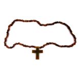 A carved horn cross necklace, L. 47cm.