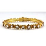 A 22ct yellow gold (stamped 22ct) stone set bangle, Dia. 5.5cm.