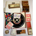A boxed roulette and a quantity of card games and board game tokens.