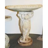 A concrete garden bird bath supported by cherubs, H. 72cm Dia. 64cm.