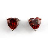 A pair of 9ct white gold heart cut garnet set stud earrings, L. 0.7cm.