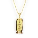 An Egyptian yellow metal pendant (tested minimum 14ct gold) on a 9ct gold chain, L. 4cm.