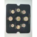 A tray containing nine hand painted 'The predecimals of Elizabeth II' coins.