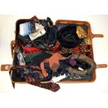 A suitcase containing a large quantity of vintage ties, handkerchiefs and other items.
