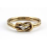 A 9ct yellow gold stone set knot ring, (M.5).