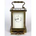 A miniature brass carriage clock, H. 8cm. With key.