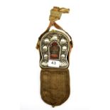 A Tibetan white metal and copper ga'u (portable shrine) in a silk carrying case, L. 13cm.