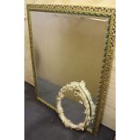 A white painted and gilt gesso framed Rococo style oval mirror together with a large gilt framed
