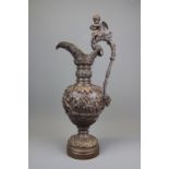 A large 19th century continental bronze ewer decorated with a cherub, H. 58cm.