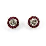 A pair of 18ct white gold (stamped 750) ruby and diamond set halo earrings, Dia. 0.7cm.