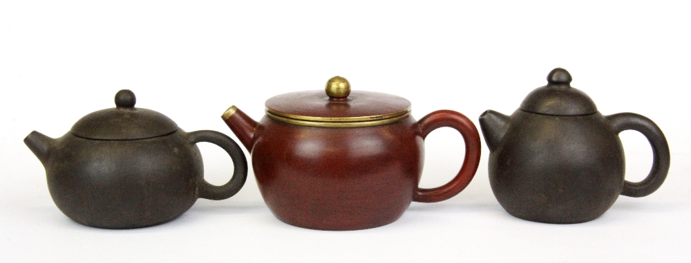 Three Chinese Yixing terracotta miniature teapots, tallest H. 8cm.