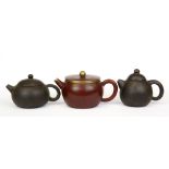 Three Chinese Yixing terracotta miniature teapots, tallest H. 8cm.
