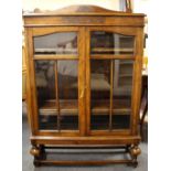 A carved oak glass fronted display cabinet, 140 x 86 x 29cm.