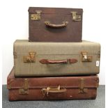 Three vintage suit cases.