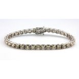 An 18ct white gold (stamped 750) tennis bracelet set with brilliant cut diamonds, approx. 9.94ct