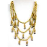 An Indian silk and gilt metal adjustable necklace, with yellow metal (tested 22ct gold) drops set