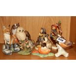 Three Goebel pottery figures and five Scottish resin figures.