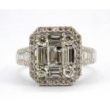 An 18ct white gold (stamped 750) cluster ring set with 1.54ct of baguette and brilliant cut