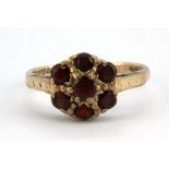 A 9ct yellow gold garnet set cluster ring, (N).