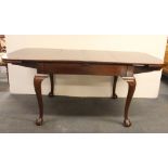 A 19th Century ball and claw foot mahogany extending dining table together with purchase receipt,