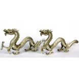 A pair of silver plated bronze figures of dragons, L. 33cm.