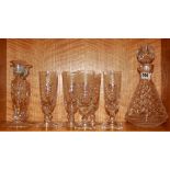 A set of six etched glass champagne glasses, a glass decanter and a pair of candlesticks, decanter