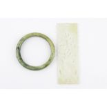 A Chinese carved jade box panel and a nephrite jade bangle, bangle Dia. 6cm, panel L. 12.5cm.