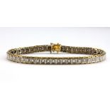 A 14ct yellow and white gold diamond set box bracelet, L. 18cm.