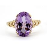 A 9ct yellow gold ring set with an oval cut amethyst, (U.5).