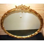 A large gilt framed oval mirror, size 124 x 109cm.