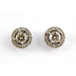 A pair of 18ct white gold (stamped 750) diamond set halo earrings, with removable halo to convert