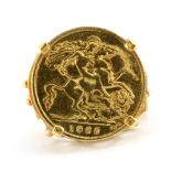A yellow metal (tested minimum 9ct gold) mounted half sovereign ring, (M).