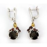 A pair of 925 silver drop earrings set with swiss cut smokey quartz, garnets and marquise cut