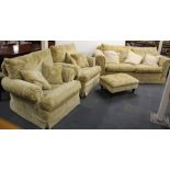 A contemporary furniture suite comprising a three seater settee, two armchairs, foot stool and a