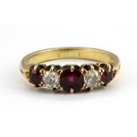 A yellow metal (tested 18ct gold) ring set with old cut diamonds and rubies, (G.5).