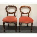 A pair of 19th Century red upholstered mahogany balloon backed dining chairs together with