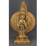 An impressive Tibetan gilt bronze figure of a thousand arm and multi head deity, H. 70cm.