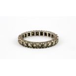 A 9ct white gold spinel set full eternity ring, (N).