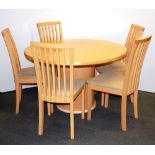 An unusual Skovby circular extending pedestal dining table with five matching chairs, extended