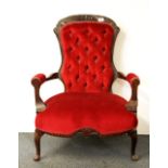 A button back red upholstered armchair, H. 90cm.