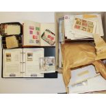 A quantity of loose stamps and two small stamp albums.